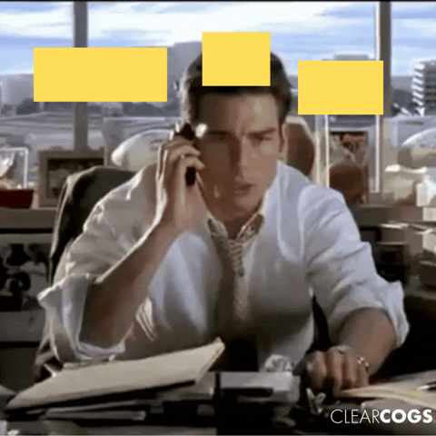 Scene of a businessman on the phone at his desk, looking urgently at documents