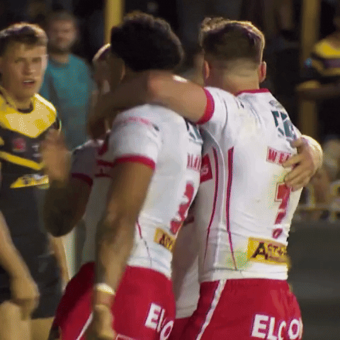 Rugby players celebrating together after a try